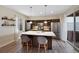 Modern kitchen featuring a large island with seating, sleek cabinets, stainless steel appliances, and wood floors at 9624 Dunning Cir, Highlands Ranch, CO 80126