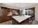 Modern kitchen featuring stainless steel appliances, dark wood cabinets and a large island with quartz countertops at 9624 Dunning Cir, Highlands Ranch, CO 80126