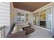 Cozy covered patio with stylish wicker seating, ambient string lights, and sliding glass door at 9624 Dunning Cir, Highlands Ranch, CO 80126