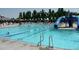 A large shared community pool with water slides and a seating area at 9624 Dunning Cir, Highlands Ranch, CO 80126