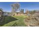 Backyard featuring large grassy area with patio and mature shade trees at 2070 Kingston St, Aurora, CO 80010