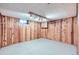 Spacious basement area with knotty wood paneled walls and spotlight lighting at 2070 Kingston St, Aurora, CO 80010