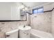 Bathroom featuring tiled walls, combination shower and tub, vanity with sink, and window at 2070 Kingston St, Aurora, CO 80010