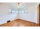 Bedroom with wood floors, two windows and a ceiling fan with lights at 2070 Kingston St, Aurora, CO 80010