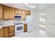 Bright kitchen featuring plentiful cabinet space, modern white appliances, and adjacent breakfast nook at 2070 Kingston St, Aurora, CO 80010