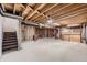 Unfinished basement with exposed wooden beams and concrete floor, offering potential for customization and expansion at 679 S Pearl St, Elizabeth, CO 80107