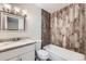 Bathroom featuring wood-look tile shower surround, granite countertop, and modern fixtures at 679 S Pearl St, Elizabeth, CO 80107