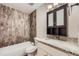 Bathroom featuring a granite countertop vanity and wood-look tile shower at 679 S Pearl St, Elizabeth, CO 80107