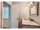 Bathroom featuring a granite countertop vanity and tile floors with a window for natural light at 679 S Pearl St, Elizabeth, CO 80107