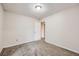 Bedroom with carpeted floors, light walls, and an open door showing the next room at 679 S Pearl St, Elizabeth, CO 80107