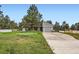 Charming home with a long driveway, mature trees, and attached garage at 679 S Pearl St, Elizabeth, CO 80107