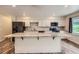 Modern kitchen featuring white cabinets, granite countertops, and stainless steel appliances at 679 S Pearl St, Elizabeth, CO 80107