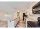 Bright kitchen with a granite island, white cabinets, and stainless steel appliances at 679 S Pearl St, Elizabeth, CO 80107