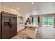 Bright, updated kitchen with a spacious island, stainless steel refrigerator and plenty of counter space at 679 S Pearl St, Elizabeth, CO 80107
