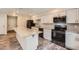 Modern kitchen features white cabinets, stainless steel appliances, and a large granite island at 679 S Pearl St, Elizabeth, CO 80107