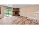 Bright living room featuring a stone fireplace, sliding glass door and staircase at 679 S Pearl St, Elizabeth, CO 80107