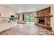 Inviting open space connecting the kitchen to a stunning stone fireplace and outdoor access at 679 S Pearl St, Elizabeth, CO 80107