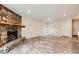 Spacious living area featuring a striking stone fireplace and wood-look tile floors at 679 S Pearl St, Elizabeth, CO 80107