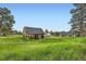Outbuilding with a sturdy wooden frame and gabled roof, offering versatile space for storage or hobbies at 679 S Pearl St, Elizabeth, CO 80107