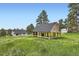 A spacious outbuilding with a wooden frame, perfect for projects or enjoying the outdoors, near the main house at 679 S Pearl St, Elizabeth, CO 80107