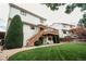 Spacious, well-maintained backyard with a deck, stairs, lush lawn, and mature landscaping, offering privacy and charm at 17530 E Caspian Pl, Aurora, CO 80013