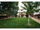 Spacious backyard with lush lawn and mature trees, complemented by a cozy deck and staircase at 17530 E Caspian Pl, Aurora, CO 80013