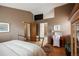 Bedroom featuring hardwood floors, neutral walls, and access to the ensuite bathroom at 17530 E Caspian Pl, Aurora, CO 80013