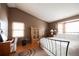 Bedroom has hardwood floors, vaulted ceiling, and a light wood armoire between two large windows at 17530 E Caspian Pl, Aurora, CO 80013