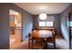 Cozy dining room with hardwood floors, view into the kitchen, and a unique light fixture at 17530 E Caspian Pl, Aurora, CO 80013