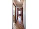 Hallway with hardwood floors leading to rooms including a bathroom and office area at 17530 E Caspian Pl, Aurora, CO 80013