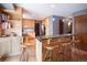 Bright kitchen featuring a breakfast bar with granite countertops and modern stainless steel appliances at 17530 E Caspian Pl, Aurora, CO 80013