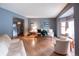 Bright living room featuring hardwood floors, a large window, and comfortable seating at 17530 E Caspian Pl, Aurora, CO 80013