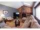 Cozy living room with a brick fireplace, vaulted ceilings, and comfortable seating arrangement at 17530 E Caspian Pl, Aurora, CO 80013