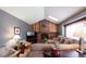 Inviting living room featuring a brick fireplace, vaulted ceilings, and comfortable seating at 17530 E Caspian Pl, Aurora, CO 80013