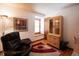 Cozy office with a comfortable chair, natural light, and storage cabinets at 17530 E Caspian Pl, Aurora, CO 80013