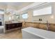 Well-lit bathroom with a modern vanity, standalone tub, and large mirror at 2999 Olympia Cir, Evergreen, CO 80439