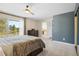 Spacious bedroom featuring large windows, soft carpet, and an attached bath at 2999 Olympia Cir, Evergreen, CO 80439