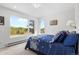 Sunlit bedroom featuring large windows with scenic views and a comfortable bed at 2999 Olympia Cir, Evergreen, CO 80439