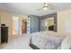 Comfortable bedroom with a blue accent wall, access to bathroom, and ample closet space at 2999 Olympia Cir, Evergreen, CO 80439