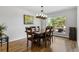 Elegant dining room with hardwood floors, a wooden table, and a window overlooking the yard at 2999 Olympia Cir, Evergreen, CO 80439
