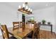 Bright dining room featuring a wood table, contemporary lighting, and hardwood floors at 2999 Olympia Cir, Evergreen, CO 80439