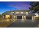 Beautiful two-story home with a well-manicured lawn, dark garage doors, and a basketball hoop out front at 2999 Olympia Cir, Evergreen, CO 80439