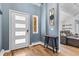 Welcoming foyer features hardwood floors, modern decor, and a glimpse into the cozy living room at 2999 Olympia Cir, Evergreen, CO 80439
