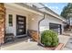 Charming front entrance with a modern door, stone accents, lush greenery, and a cozy bench at 2999 Olympia Cir, Evergreen, CO 80439