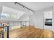 Bright hallway with hardwood floors, modern lighting, and a view of another room at 2999 Olympia Cir, Evergreen, CO 80439