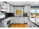 Updated kitchen features white cabinets, stainless steel appliances, and an oversized window with a view at 2999 Olympia Cir, Evergreen, CO 80439