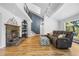 Bright living room with a stone fireplace, vaulted ceilings and access to an upper level at 2999 Olympia Cir, Evergreen, CO 80439