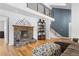 Elegant living room with a stone fireplace and wooden floors at 2999 Olympia Cir, Evergreen, CO 80439