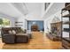 Spacious living room with vaulted ceilings, hardwood floors, and a cozy stone fireplace at 2999 Olympia Cir, Evergreen, CO 80439