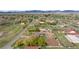 Expansive aerial view of horse property featuring a home, barn, fencing, and mountain views at 12941 W 75Th Ave, Arvada, CO 80005